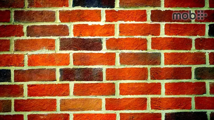 AAC block wall and red clay brick wall compared inside an RCC framed house construction site