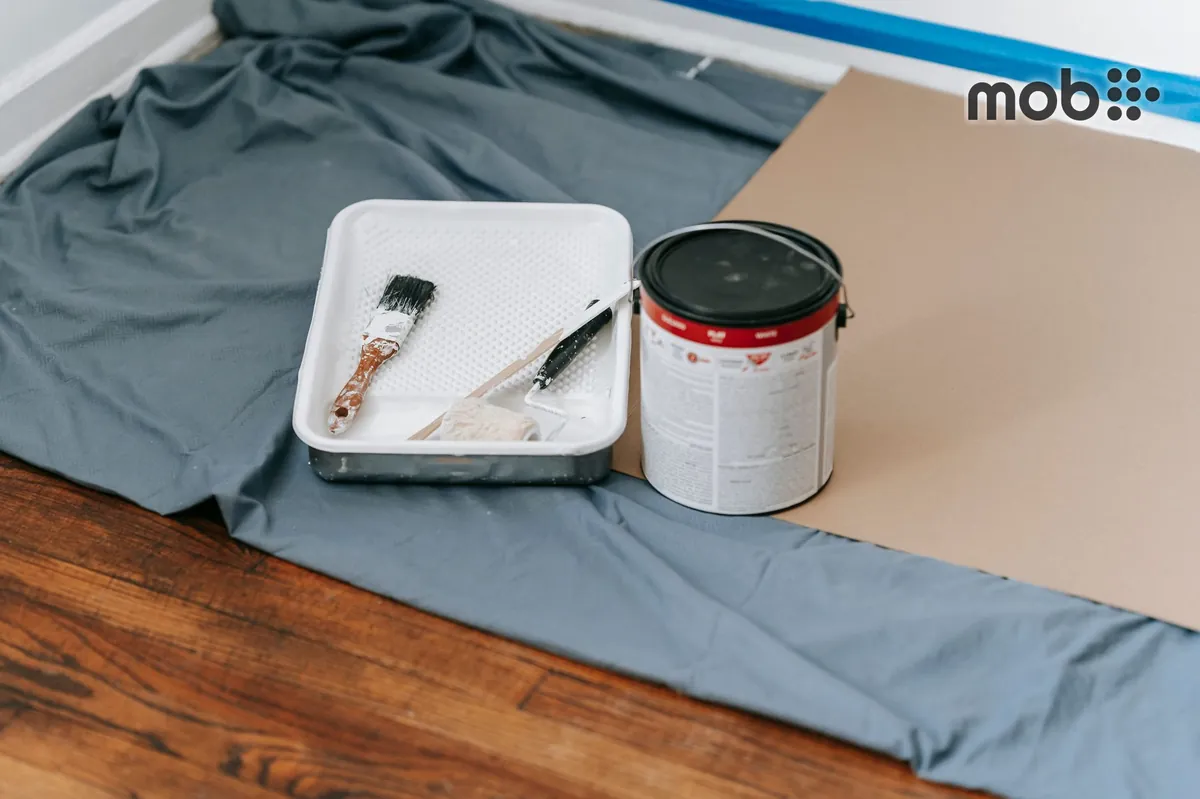 Paint cans and roller for home wall painting work