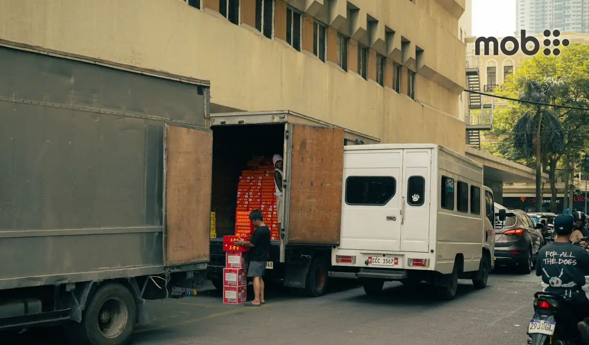 A small commercial tempo loaded with construction materials parked at a residential building site in Bengaluru