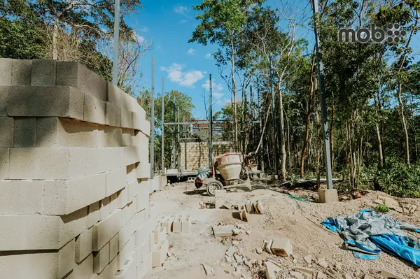 Stack of AAC blocks on a construction site with workers in Bengaluru