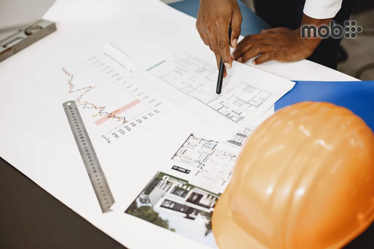 Contractor comparing material quotations against an approved construction requirement
