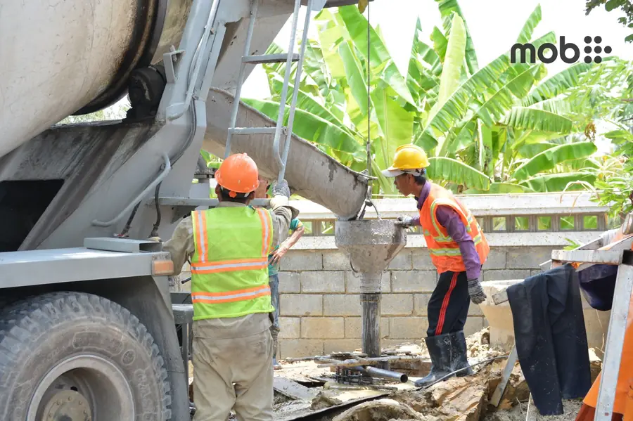Ready-mix concrete transit mixer and pump compared with controlled site-mix concrete